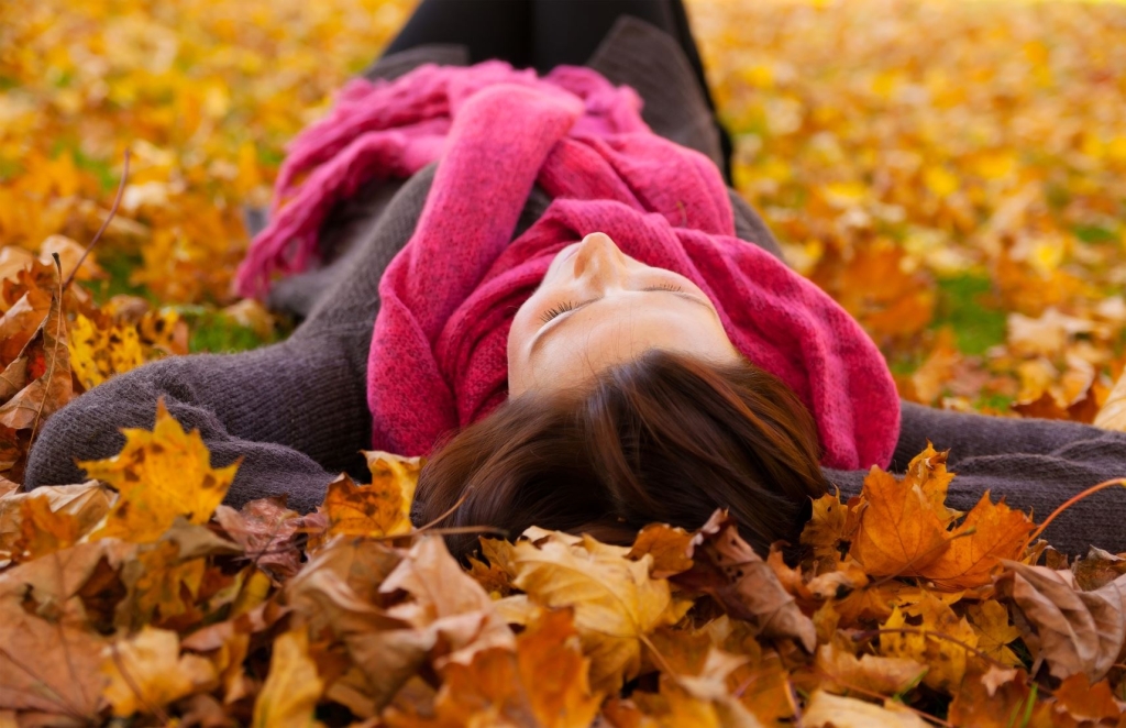Femme couchée sur des feuilles en automne